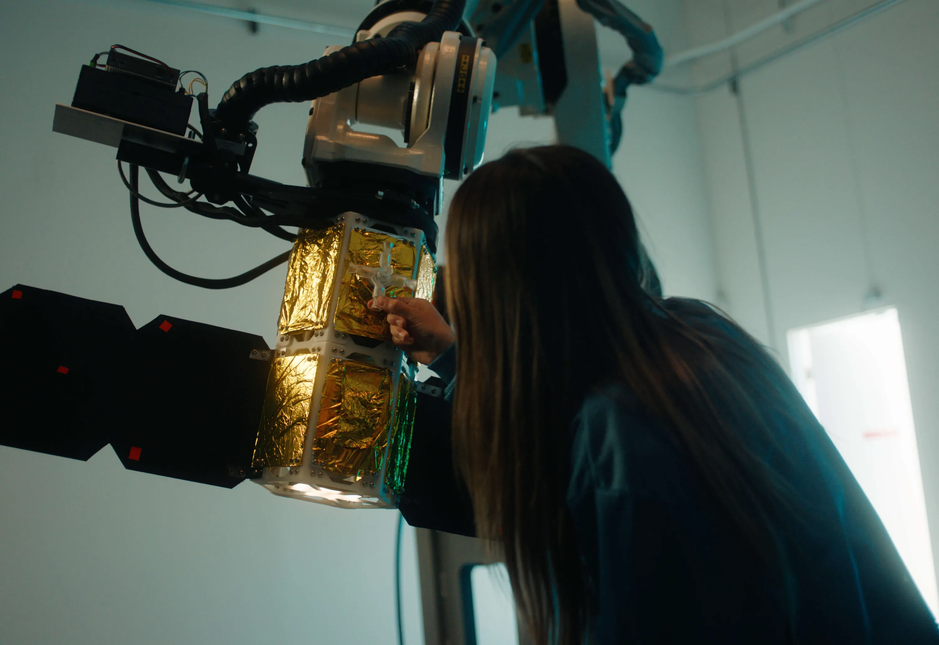 A Fortastra engineer working on flight hardware in the workshop